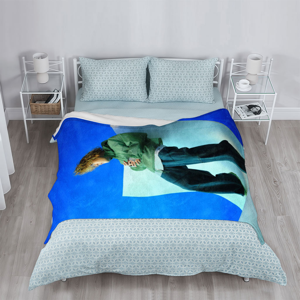 Jaden Smith in a Fashion Shoot Wearing Oversized Green Jacket and Baggy Jeans Against a Blue Background - Blankets