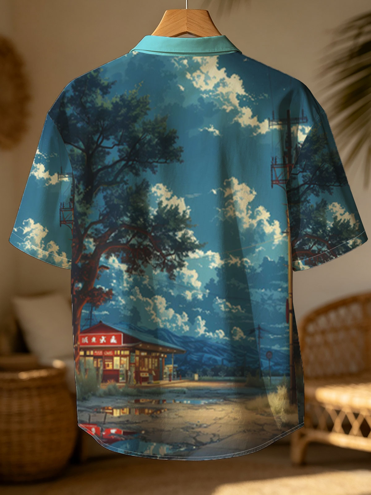 A cozy roadside shop under a vast sky, illuminated by warm lights and framed by a large tree and distant mountains. -  Shirt