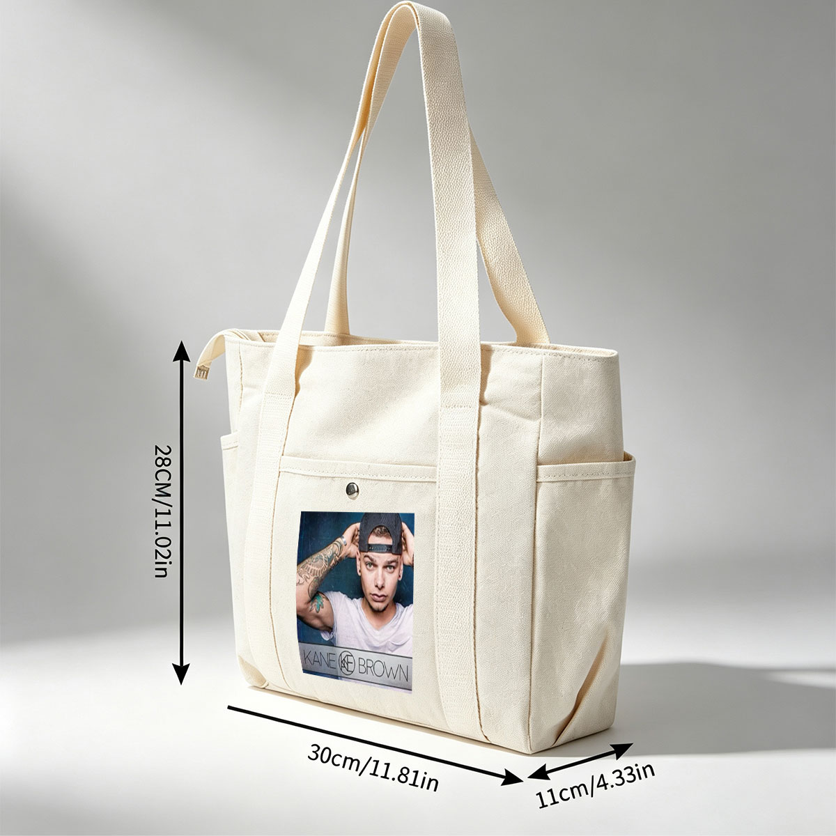 Kane Brown in a Casual Pose with Tattooed Arm and Cap on Dark Background - Multi-pocket bags