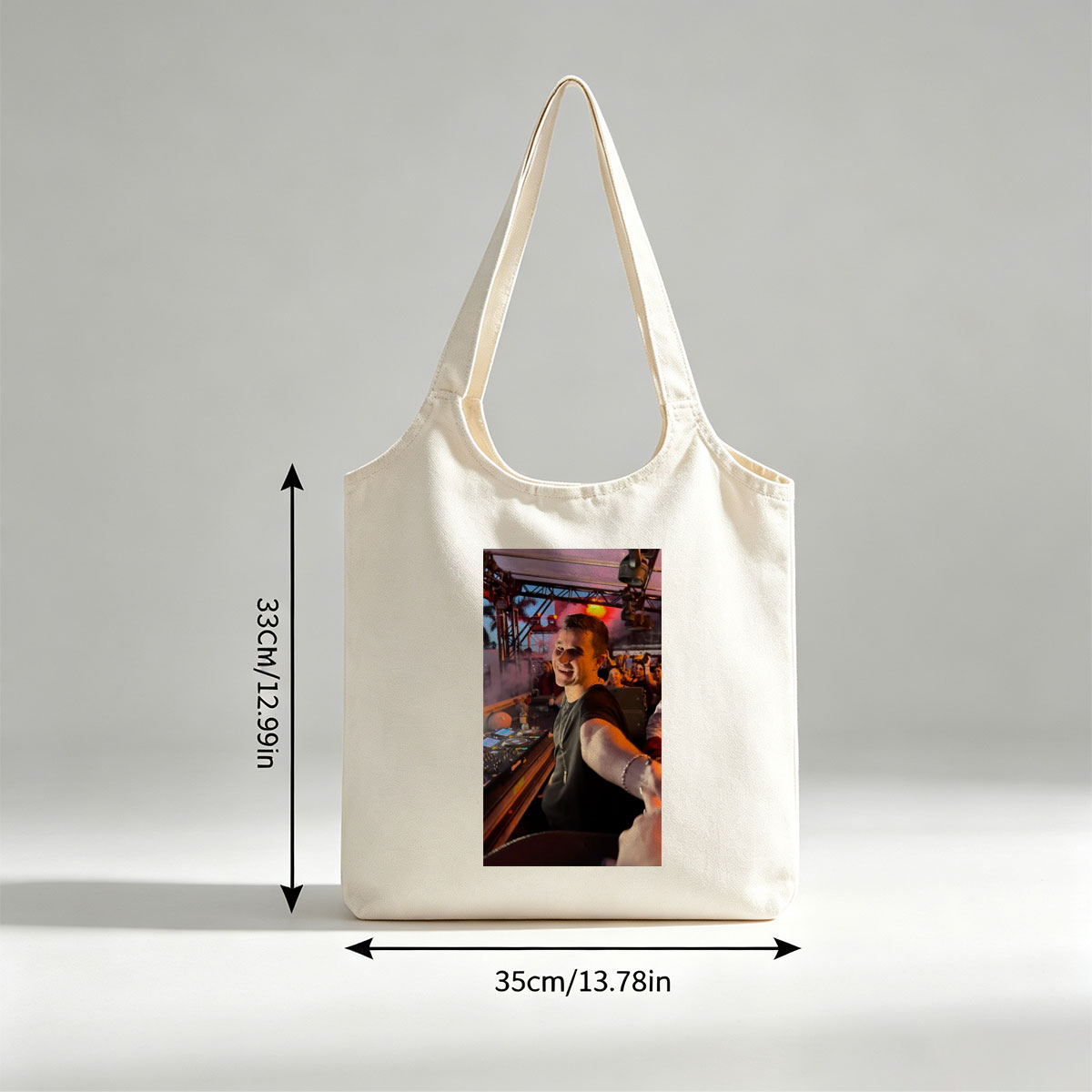 Martin Garrix at a Live DJ Set Performing for an Energetic Crowd Under Colorful Stage Lights - Canvas shoulder bags/