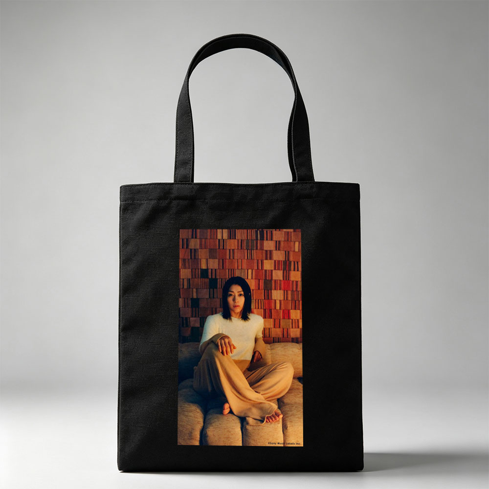 Ayaka Hirahara Sitting on Couch in Cozy Outfit Against Textured Wall Background - Canvas tote bags
