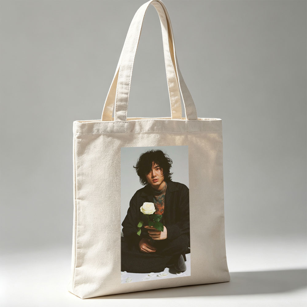 Yosuke Sugino Holding a White Rose in a Stylish Black Outfit with Petals Scattered Around - Canvas tote bags