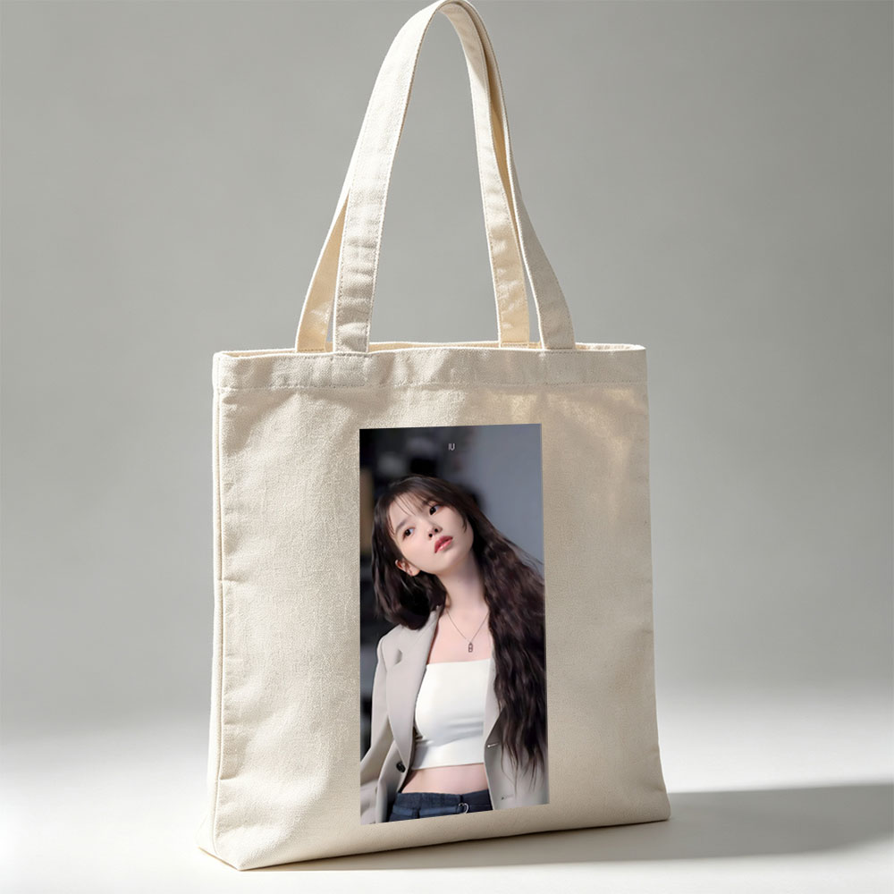 IU in a stylish outfit with a beige blazer and white crop top, showcasing her long wavy hair and elegant necklace. - Canvas tote bags