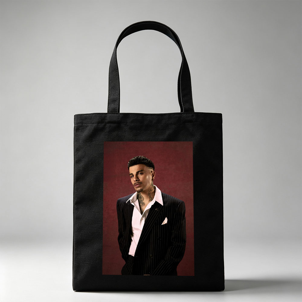 Maluma in a Pinstripe Suit Against a Deep Red Background - Canvas tote bags