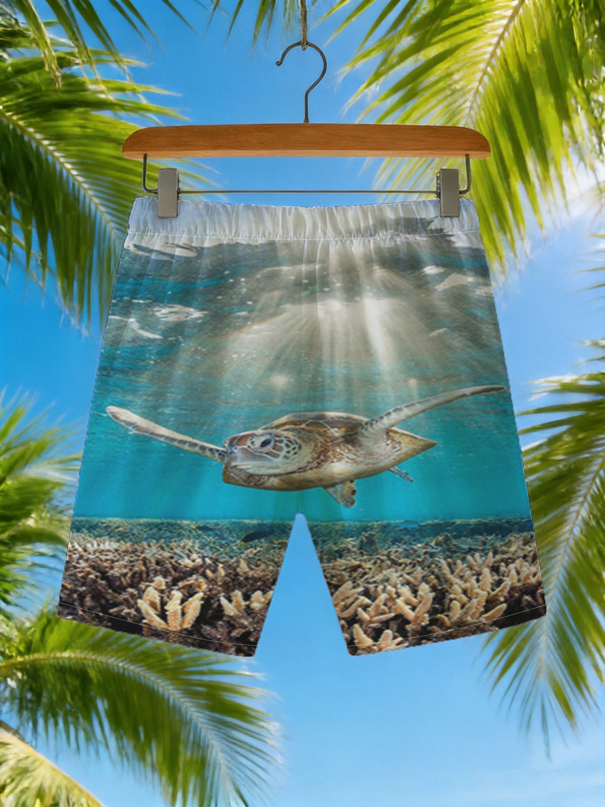 Sea turtle glides through sunlit coral reef -  Beach shorts