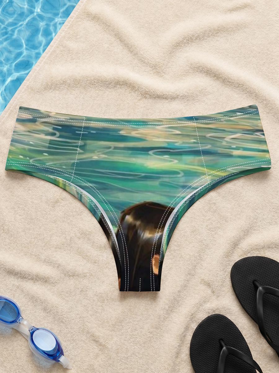 Woman swimming in clear blue water near rocky shore -  Men's swim trunks