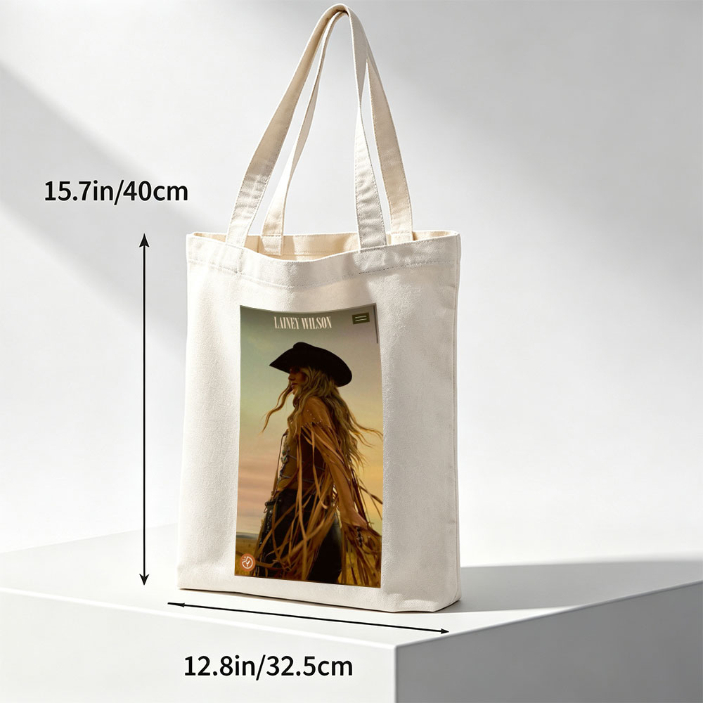 Lainey Wilson in a Cowboy Outfit Standing in a Field at Sunset - Canvas tote bags