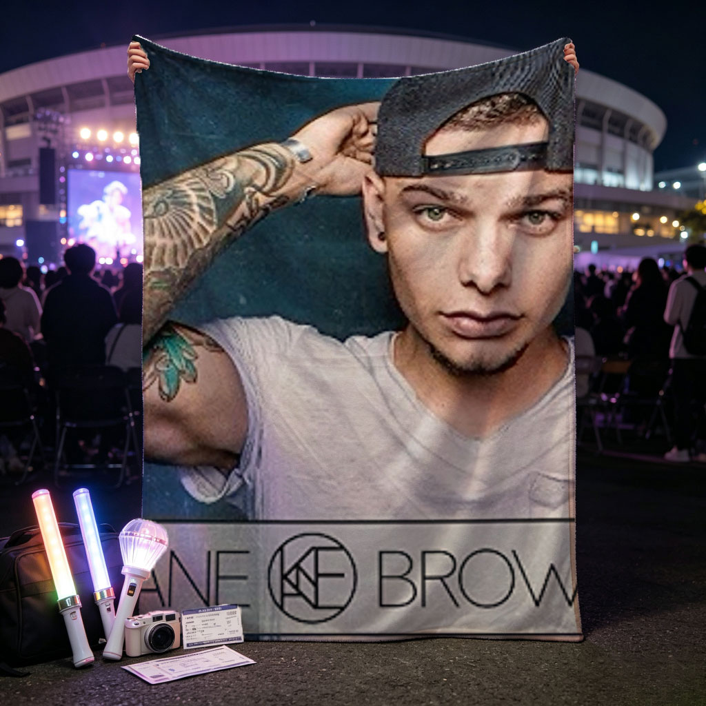 Kane Brown in a Casual Pose with Tattooed Arm and Cap on Dark Background - Blankets