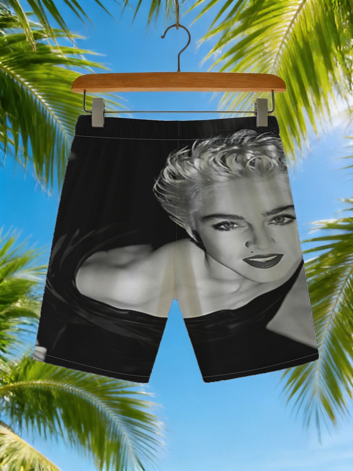 Madonna in a striking black and white portrait, showcasing bold makeup and voluminous blonde hair. -  Beach shorts