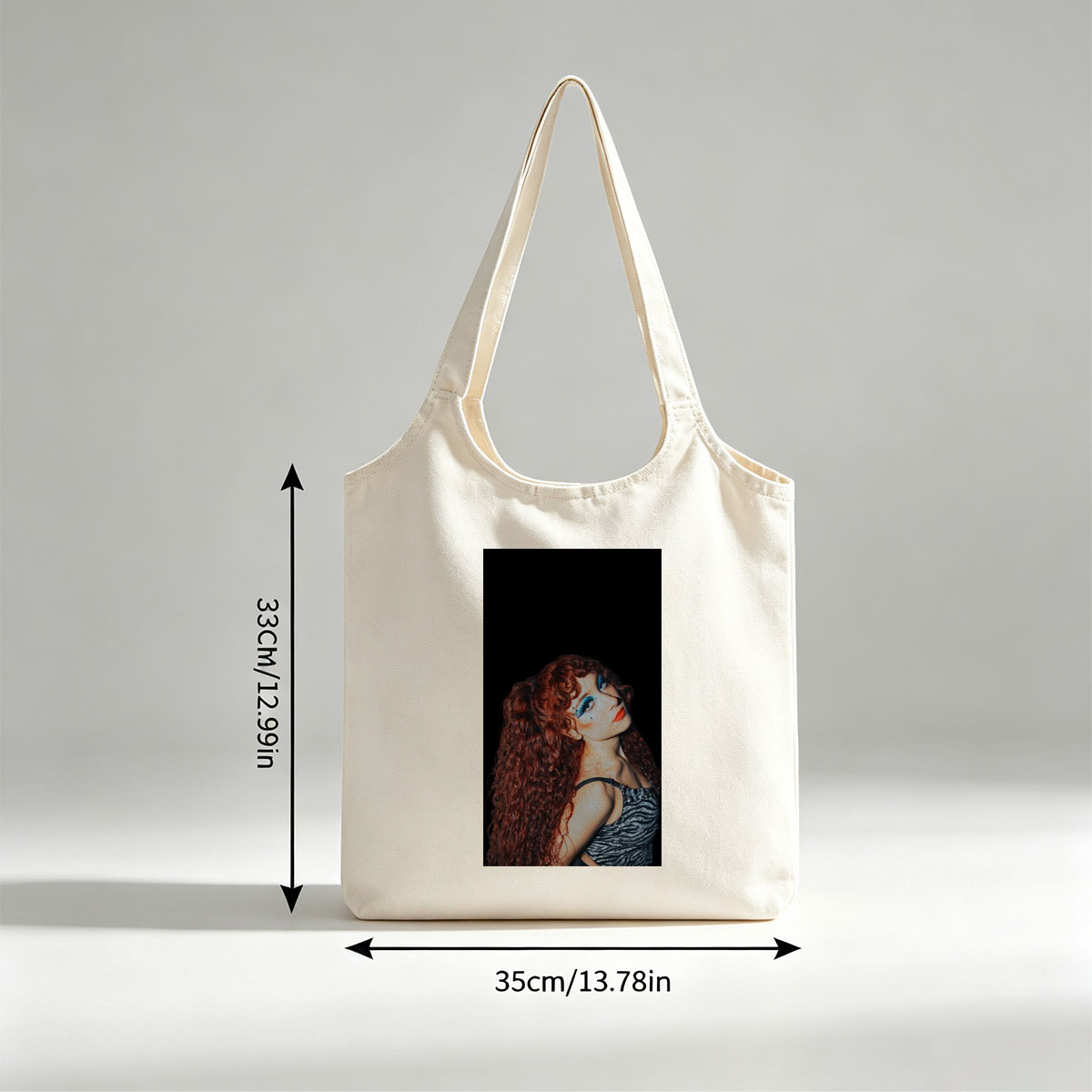 Chappell Roan in a Dramatic Pose with Vibrant Red Hair and Bold Blue Eye Makeup Against a Dark Background - Canvas shoulder bags/