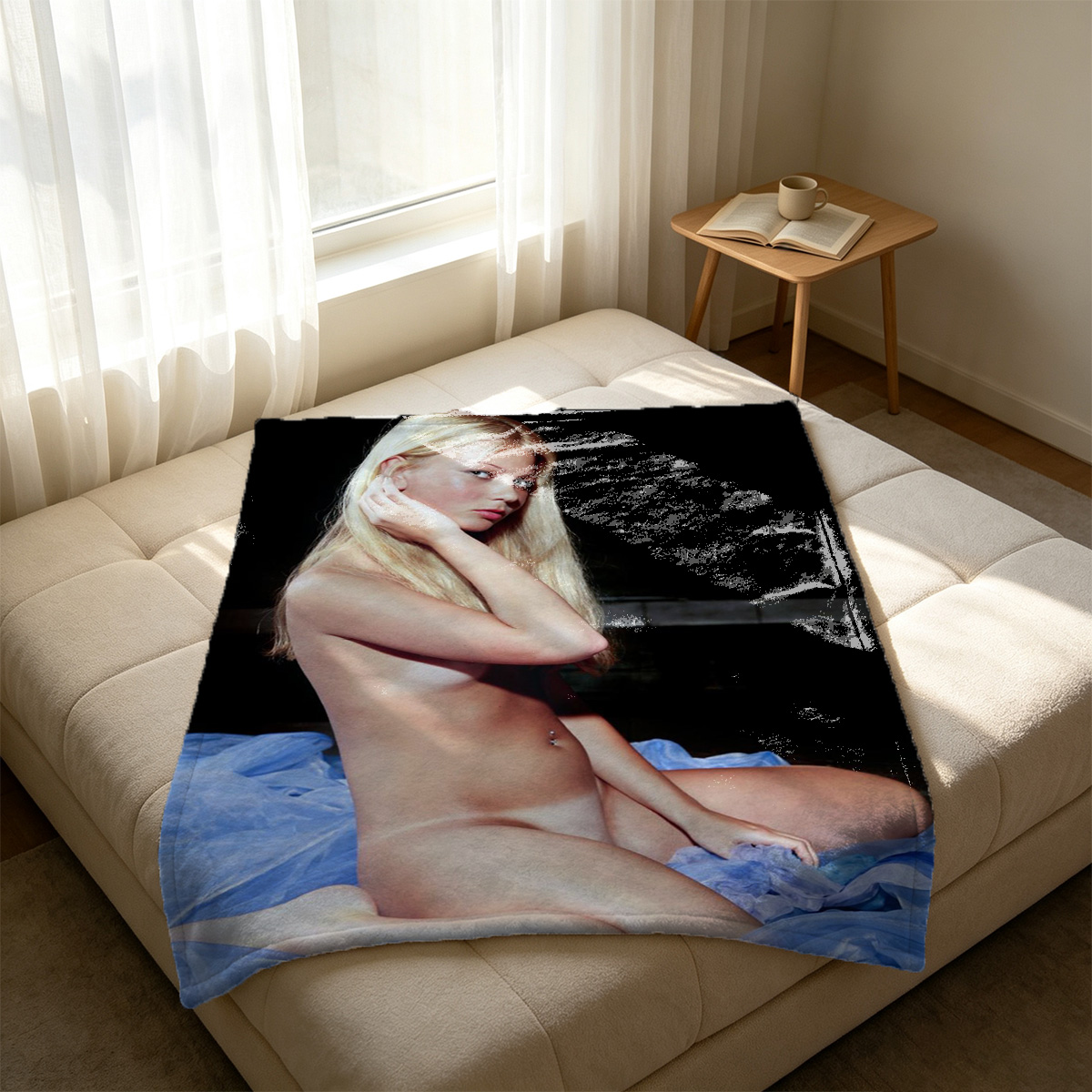 A seductive young woman in black and red lace lingerie with sheer stockings poses on a blue rug. - Blanket