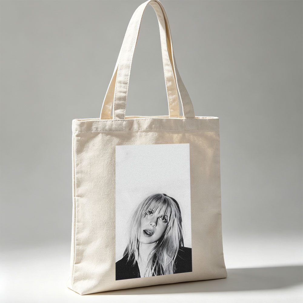 Bebe Rexha in a striking black and white portrait with tousled blonde hair and bold expression - Canvas tote bags