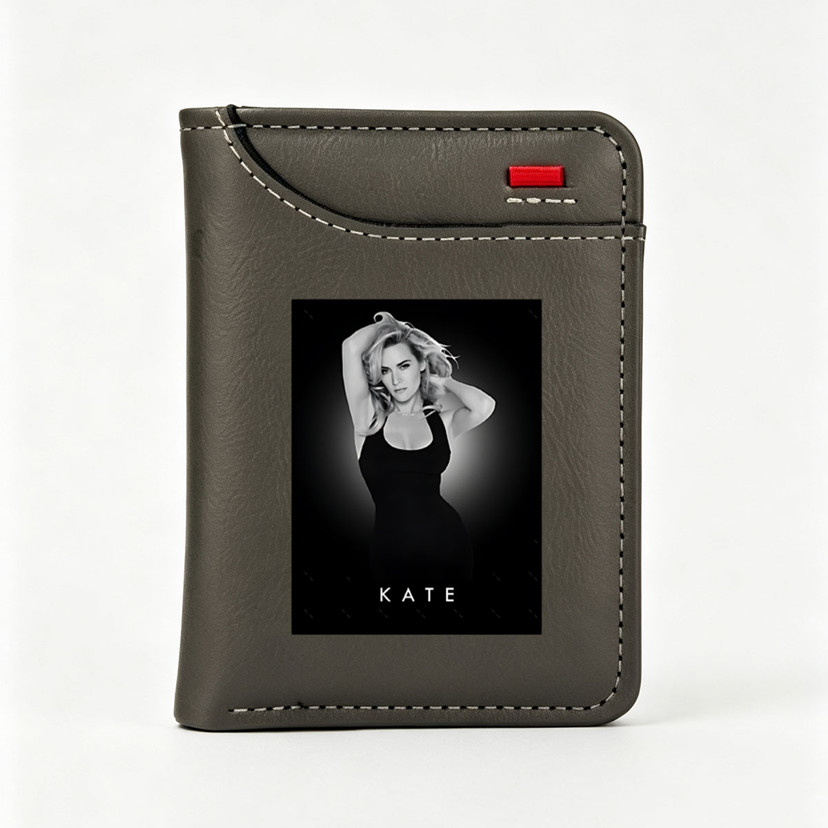Kate Winslet in a striking black dress, posing with hands in her hair against a dark background. - Vertical Style Wallet