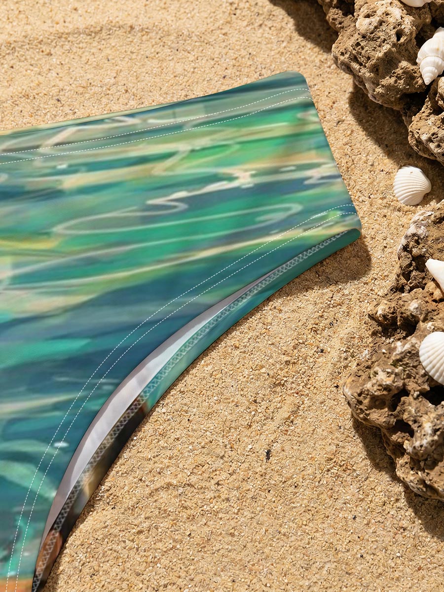 Woman swimming in clear blue water near rocky shore -  Men's swim trunks