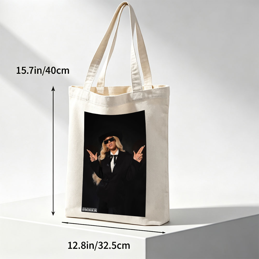 Beyonce in a Bold Black Suit and Hat Making Peace Signs Against a Dark Background - Canvas tote bags