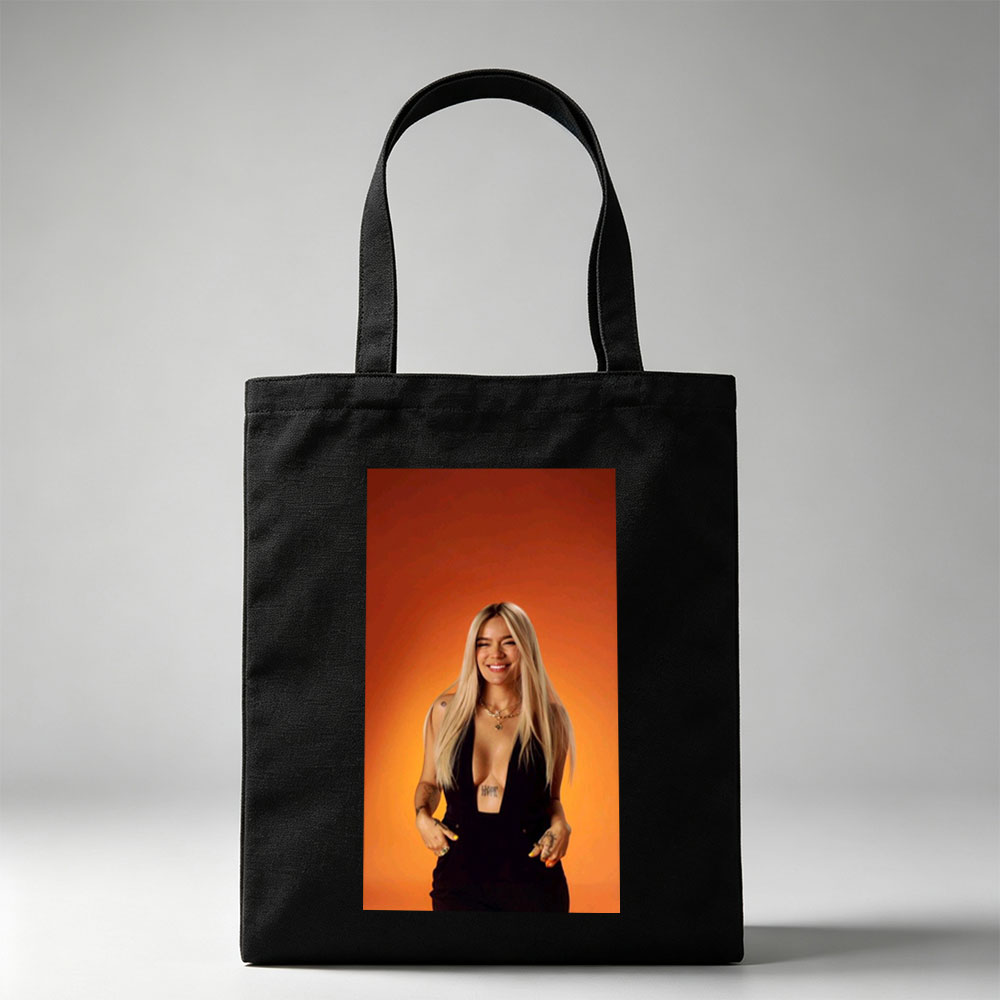 Bebe Rexha in a Bold Black Outfit Against a Vibrant Orange Background, Smiling with Confidence - Canvas tote bags