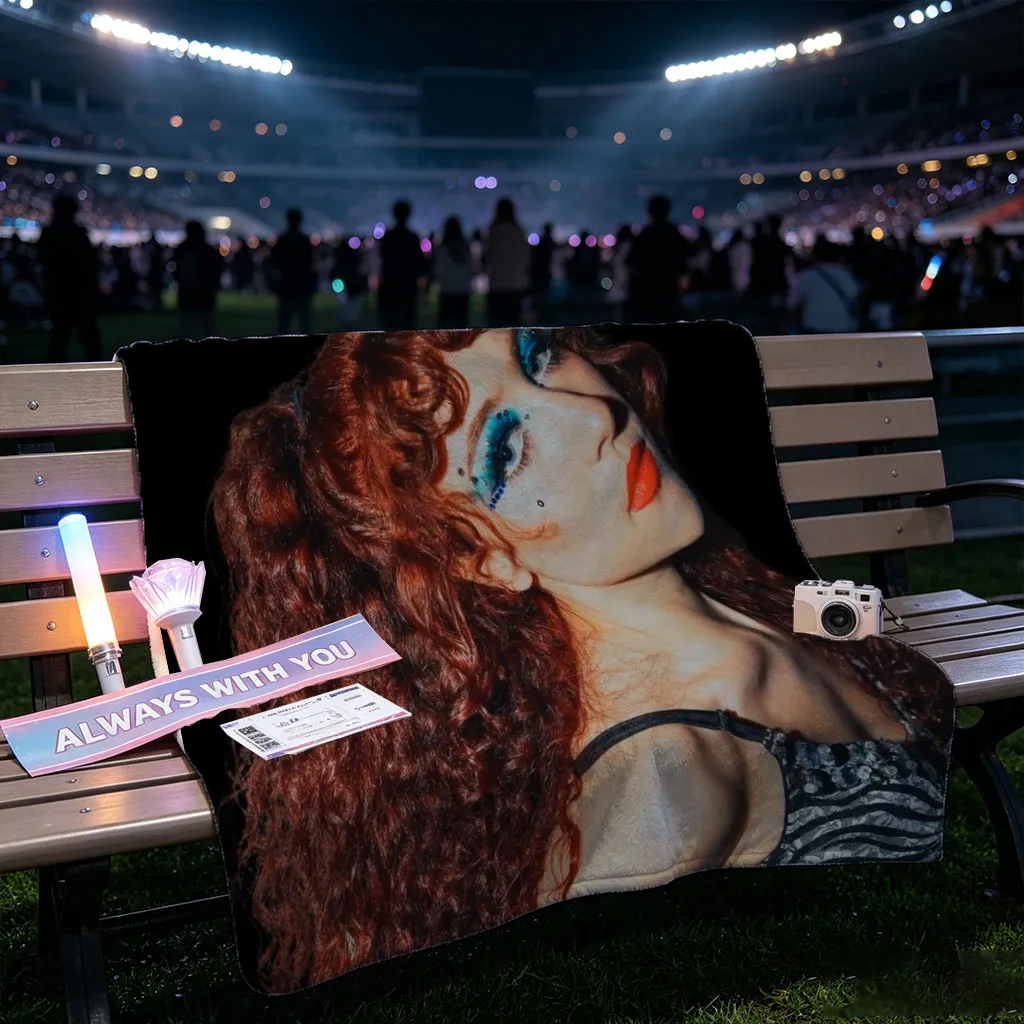 Chappell Roan in a Dramatic Pose with Vibrant Red Hair and Bold Blue Eye Makeup Against a Dark Background - Blankets