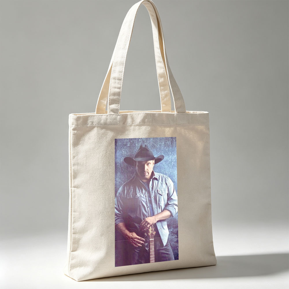 Garth Brook in Cowboy Hat Holding Guitar Against Textured Background - Canvas tote bags