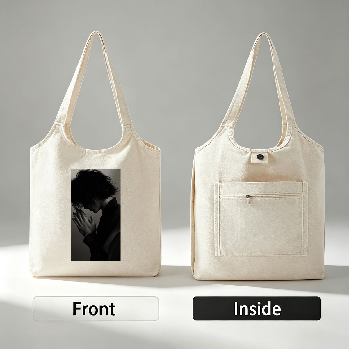 Yojiro Noda in a contemplative pose with hands clasped, captured in dramatic black and white lighting. - Canvas shoulder bags/