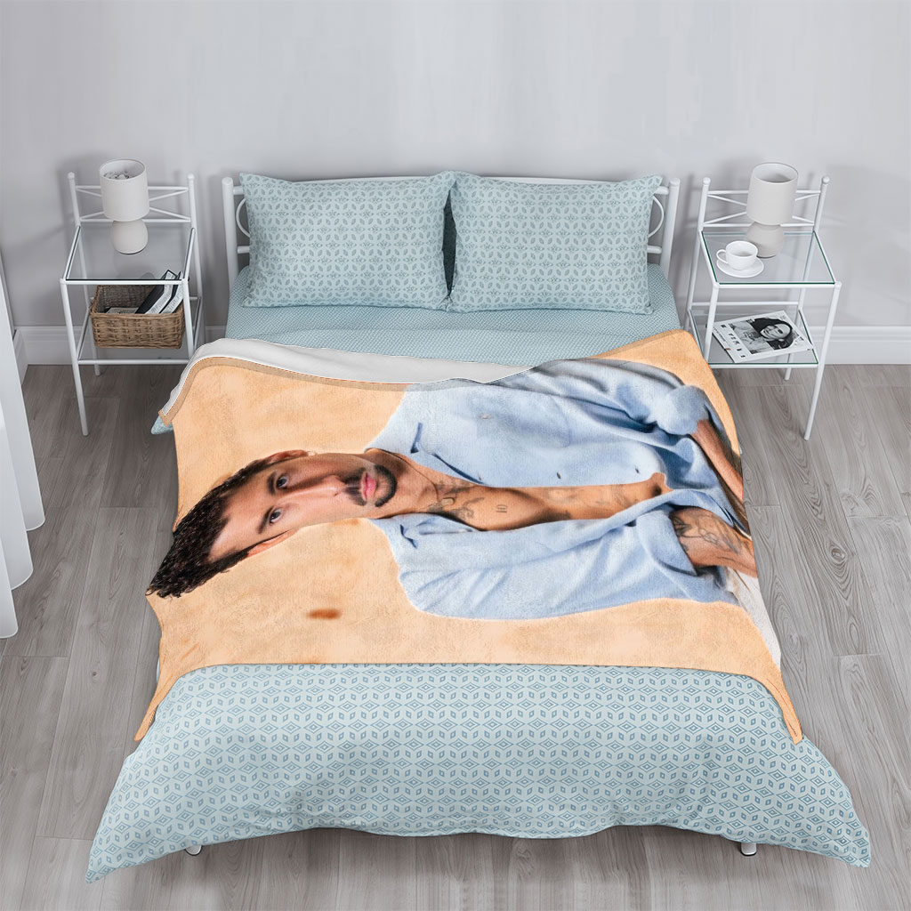 Bad Bunny in a Casual Pose Wearing an Open Light Blue Shirt and White Pants with Visible Tattoos - Blankets