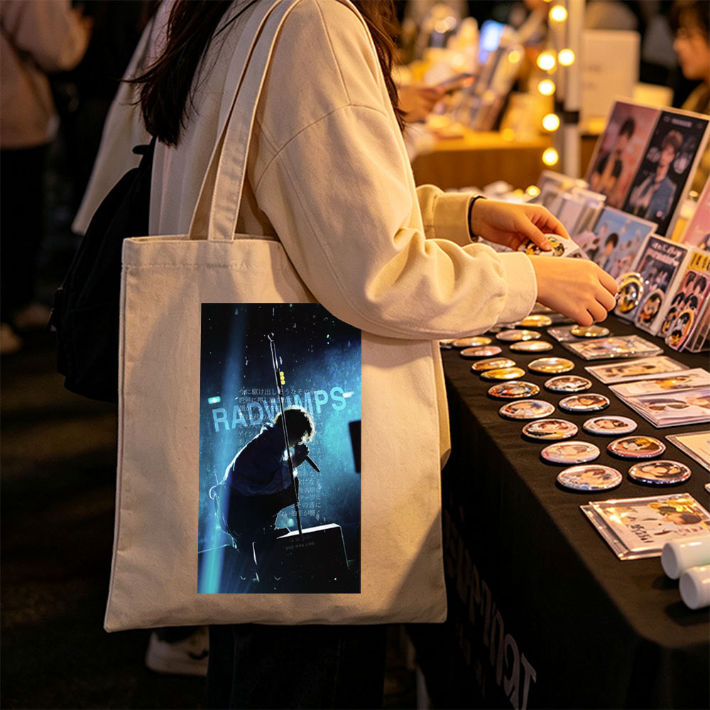 RADWIMPS Live Performance - Singer on Stage with Microphone and Dramatic Lighting - Canvas tote bags