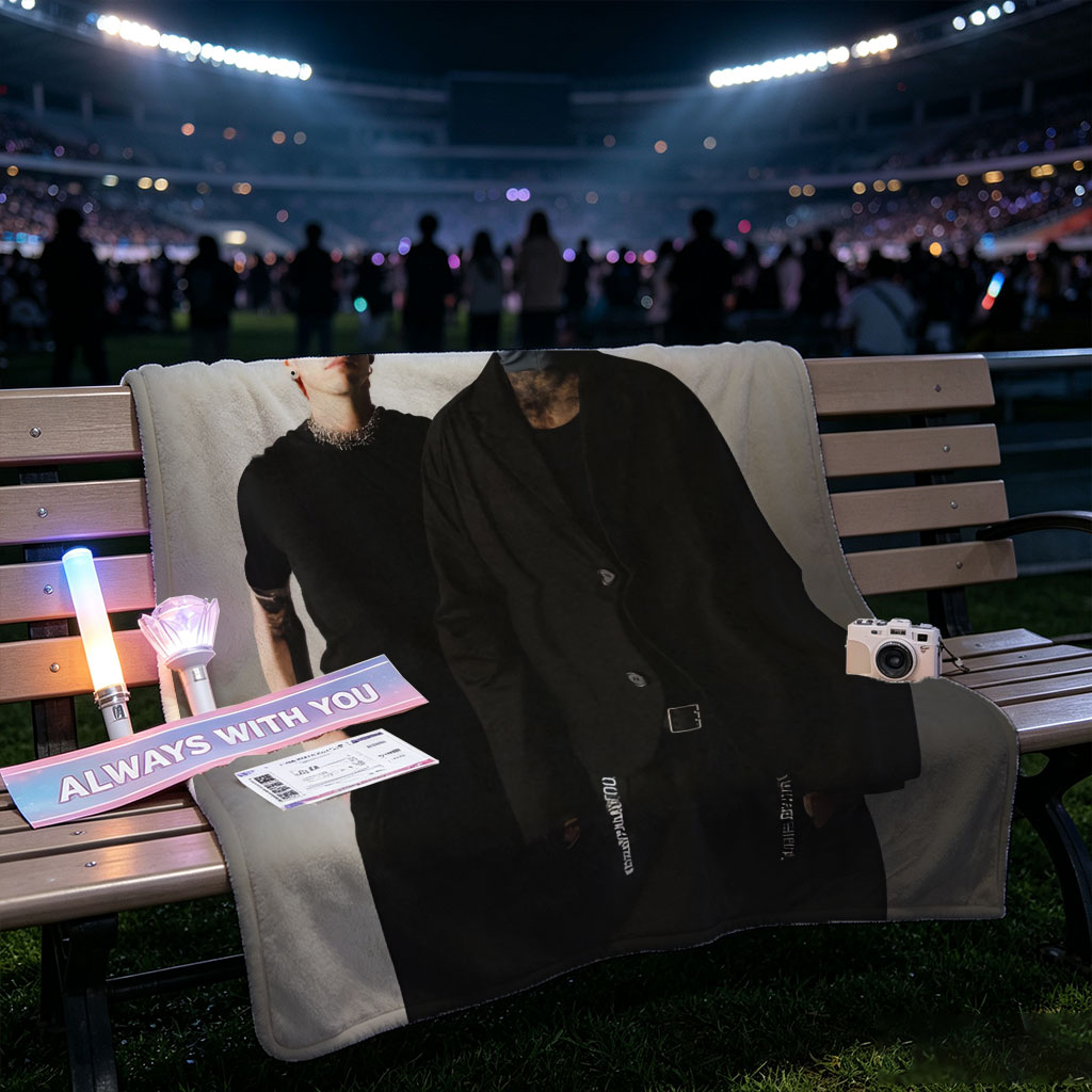 Twenty One Pilots Standing in Black Outfits with One Member Wearing a Mask and the Band Name Displayed Above Them - Blankets