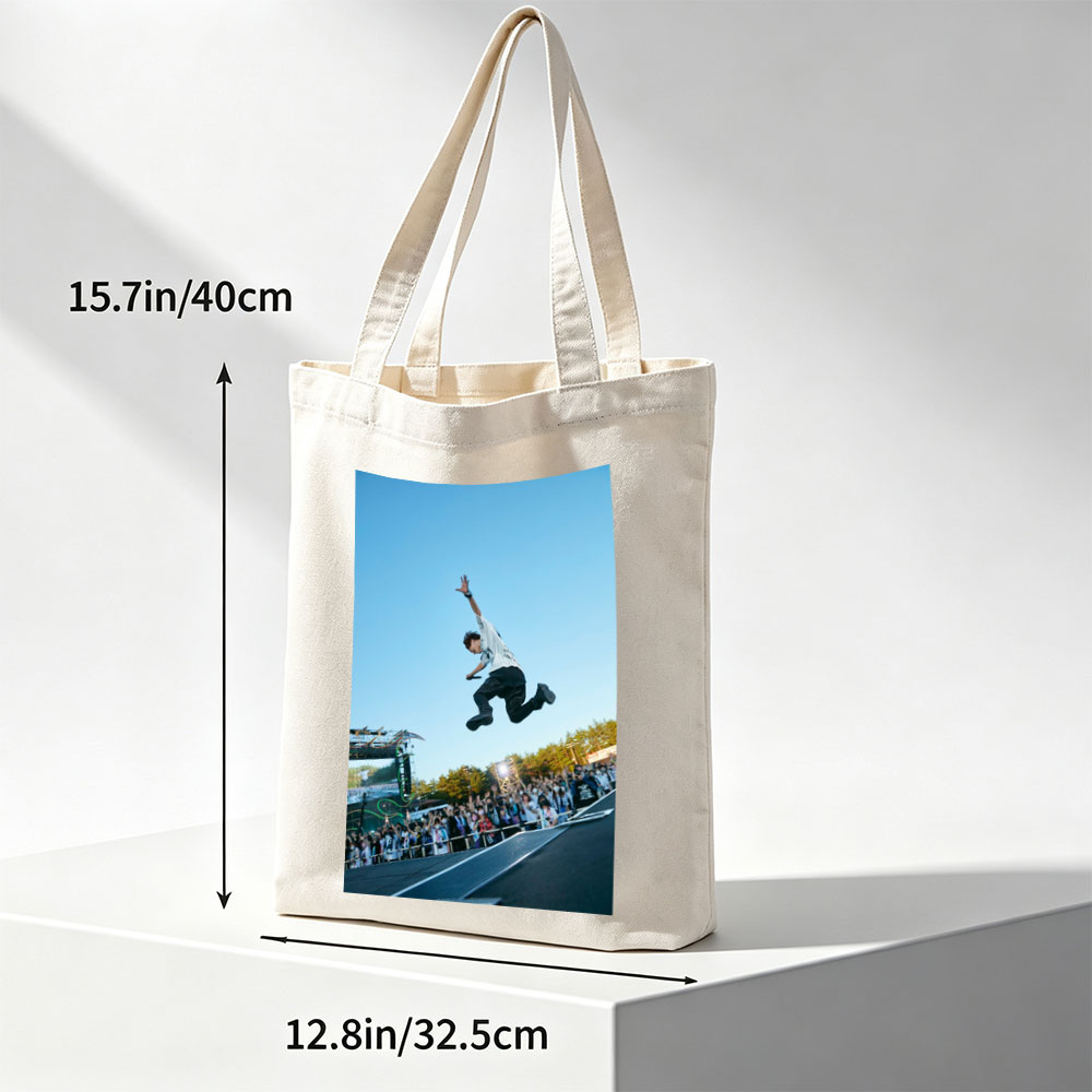 Skateboarder in Mid-Air Trick at Outdoor Festival with Crowd Watching - Canvas tote bags