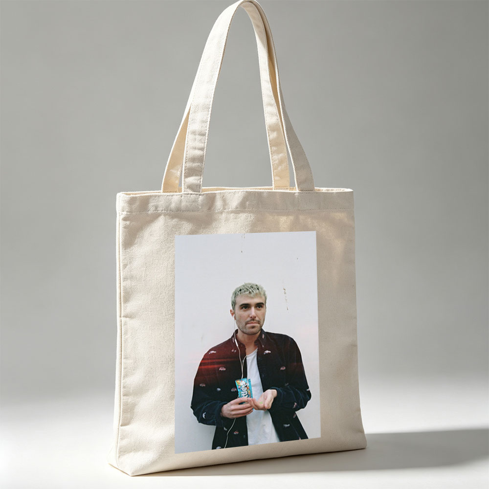 Lauv Standing Against White Wall Holding Candy Bar with Earphones - Canvas tote bags