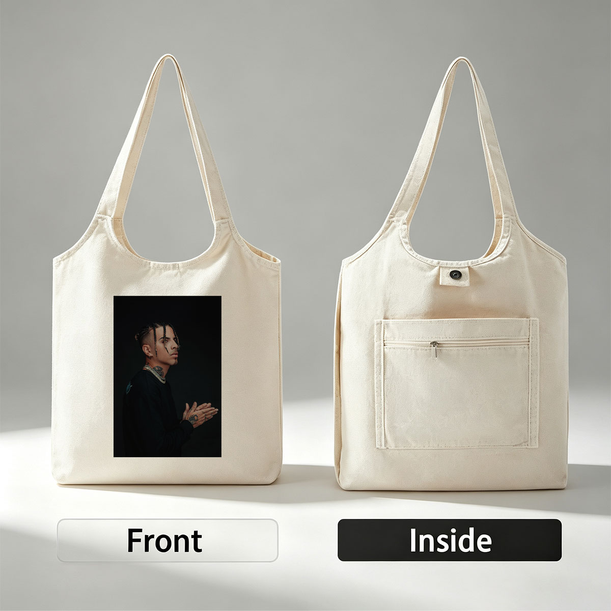 Daddy Yankee in a striking pose with braided hair and tattoos, wearing a black outfit and gold chain against a dark background. - Canvas shoulder bags/