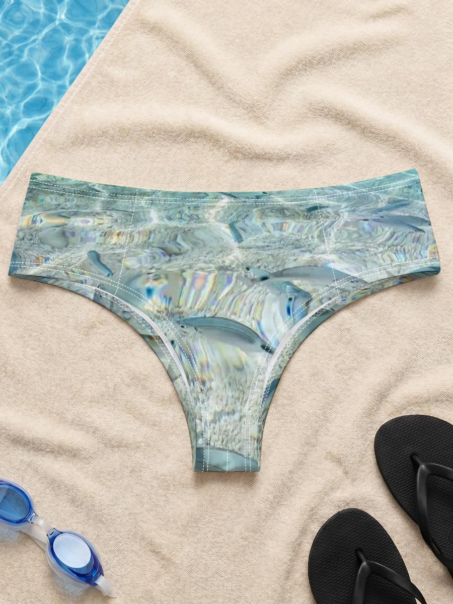 Clear waters reveal schools of fish swimming near a rocky shore with boats in the distance. -  Men's swim trunks