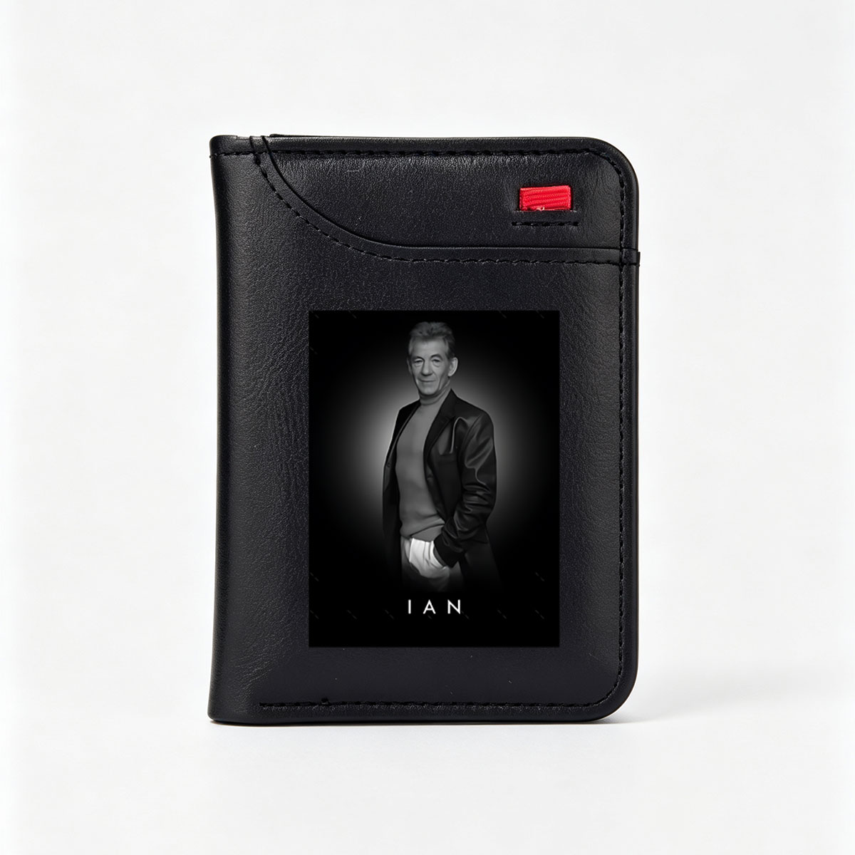 Ian McKellen in a stylish black suit, exuding elegance and confidence against a dark background. - Vertical Style Wallet