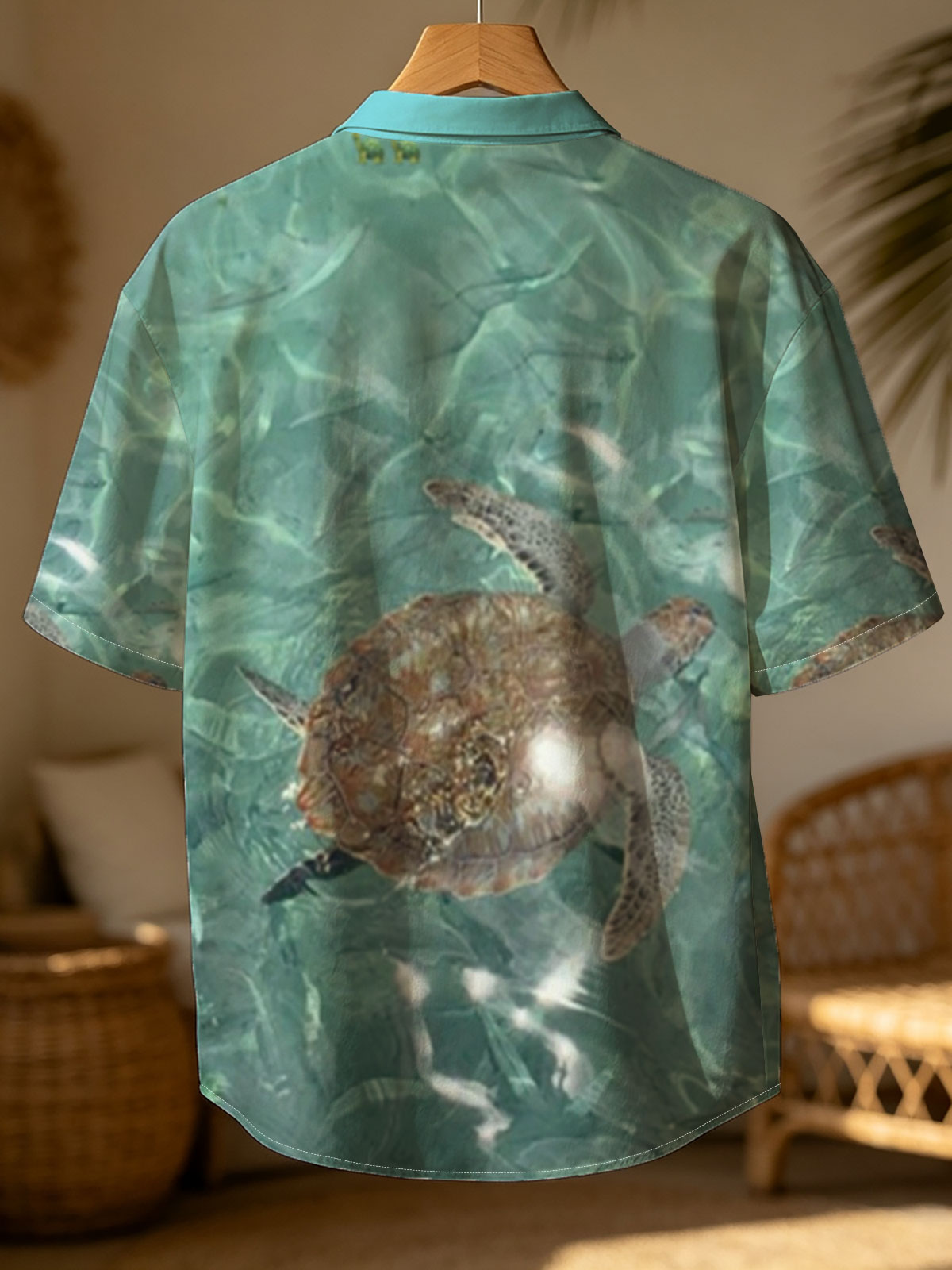 Sea turtle swims gracefully in clear turquoise waters at Playa Grandi. -  Shirt