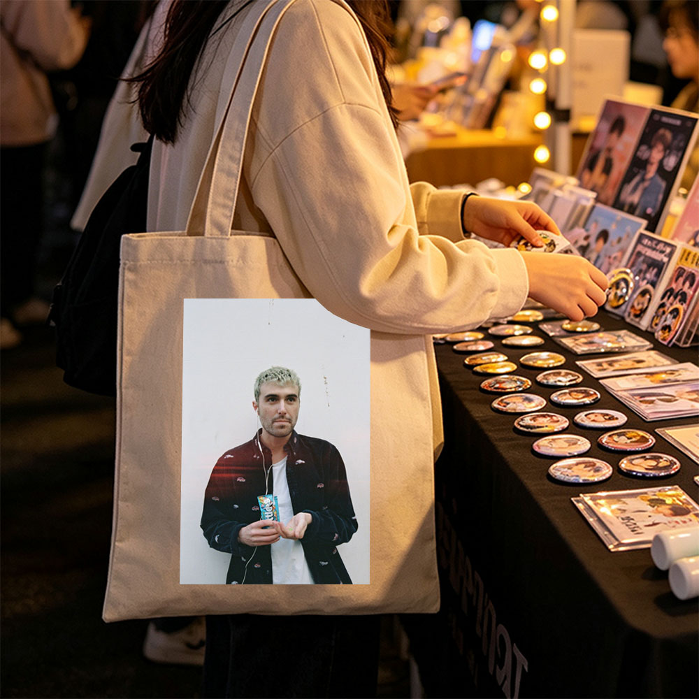 Lauv Standing Against White Wall Holding Candy Bar with Earphones - Canvas tote bags