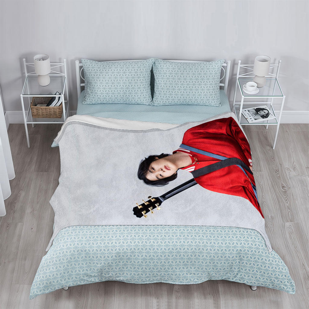 Jungkook with Guitar in Red Jacket and Blue Bag, Standing Against Gray Background - Blankets
