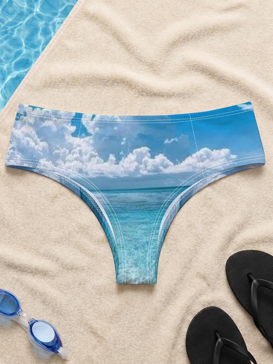 Crystal clear turquoise waters meet soft sandy beach under a vibrant blue sky with fluffy white clouds. -  Men's swim trunks