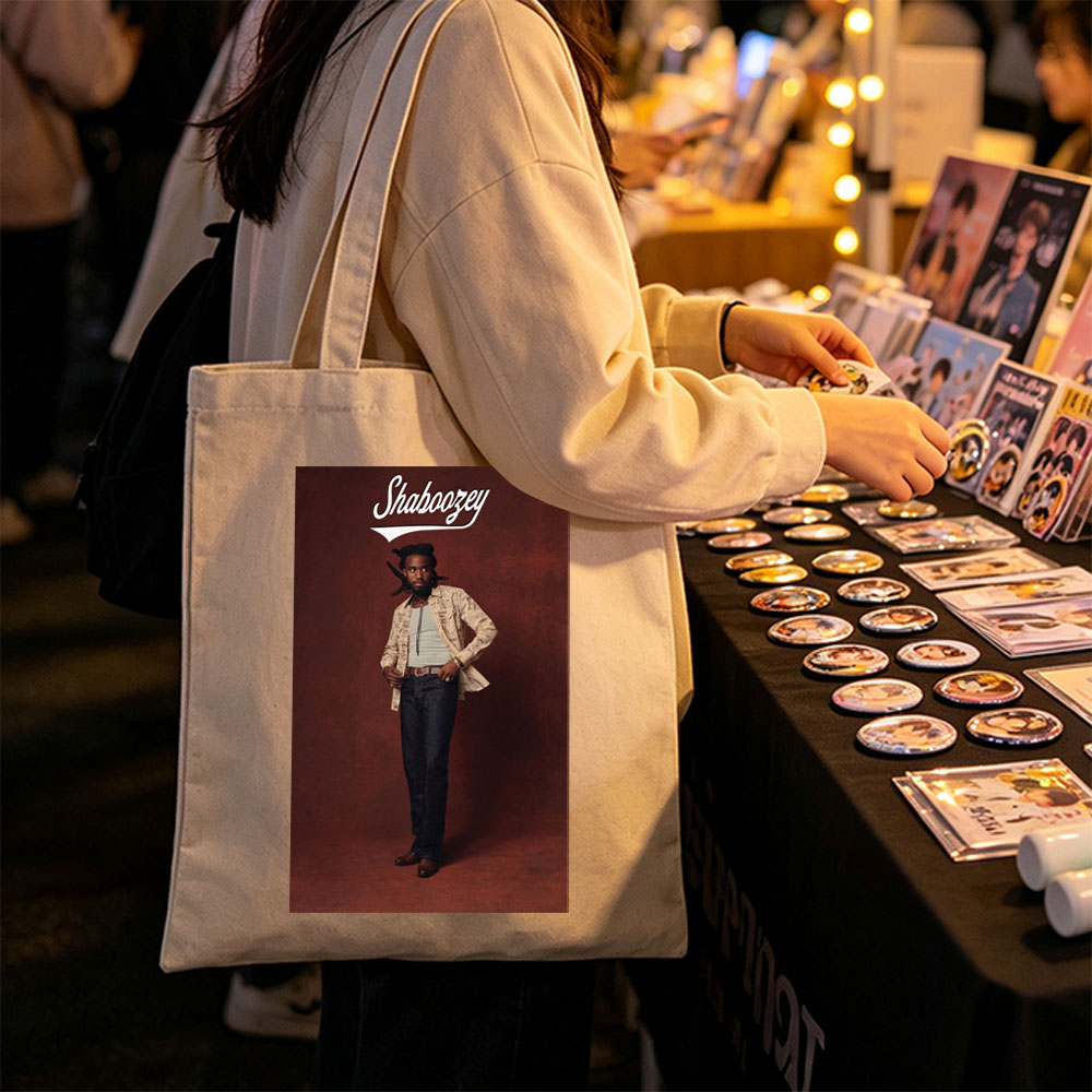 Shaboozey Standing Confidently in a Patterned Jacket and Jeans Against a Rich Red Background - Canvas tote bags
