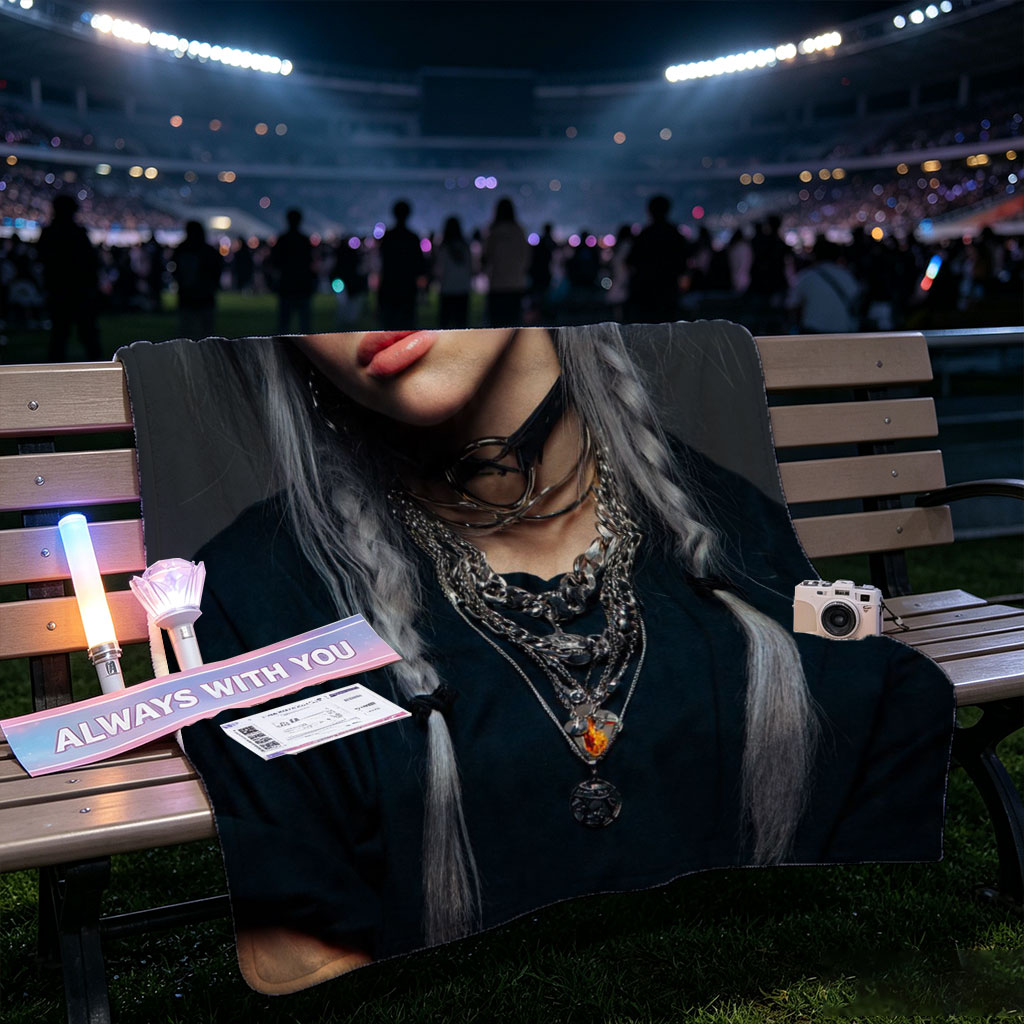 Billie Eilish in a striking portrait with silver hair styled in braids, wearing layered necklaces and a black top against a dark background. - Blankets