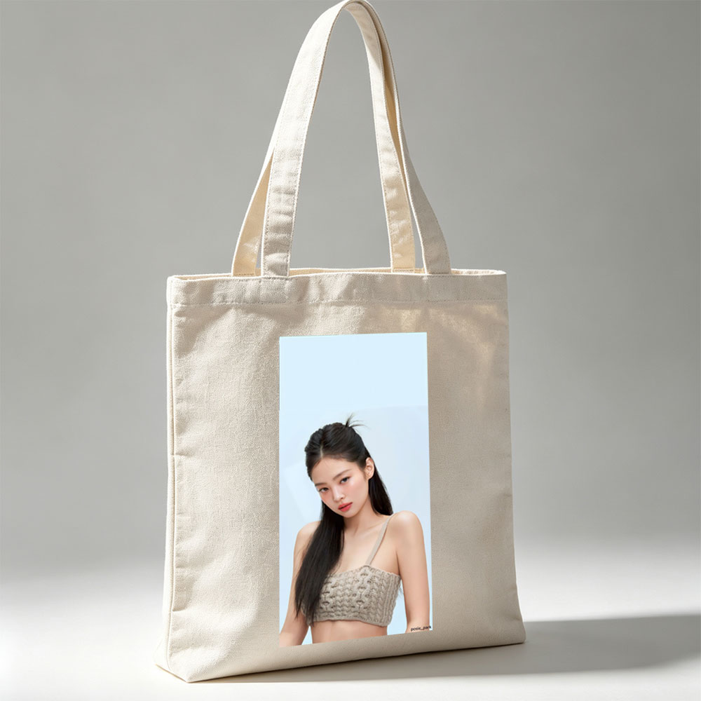 Jennie Kim in a Minimalist Look Wearing a Beige Knit Crop Top Against a Soft Blue Background - Canvas tote bags