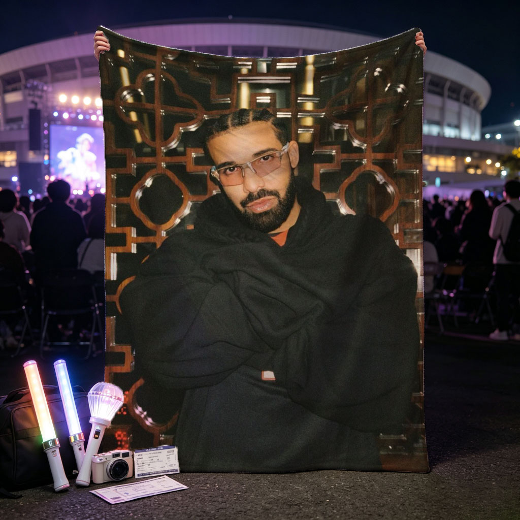 Drake in a Stylish Pose Against an Ornate Background Wearing Glasses and a Black Hoodie - Blankets