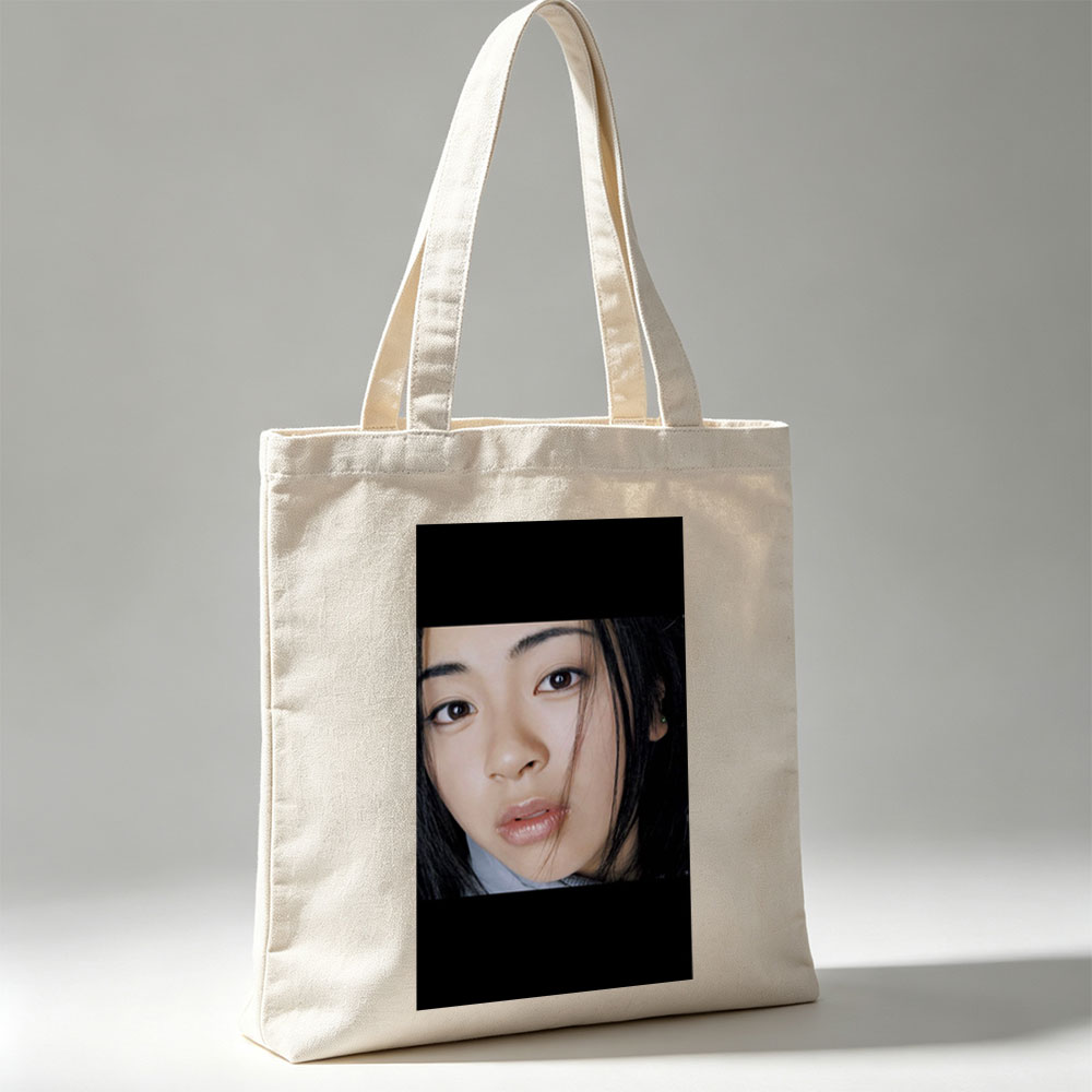 Yuki Kajiura in a Close-Up Portrait with Soft Lighting and Gentle Expression - Canvas tote bags