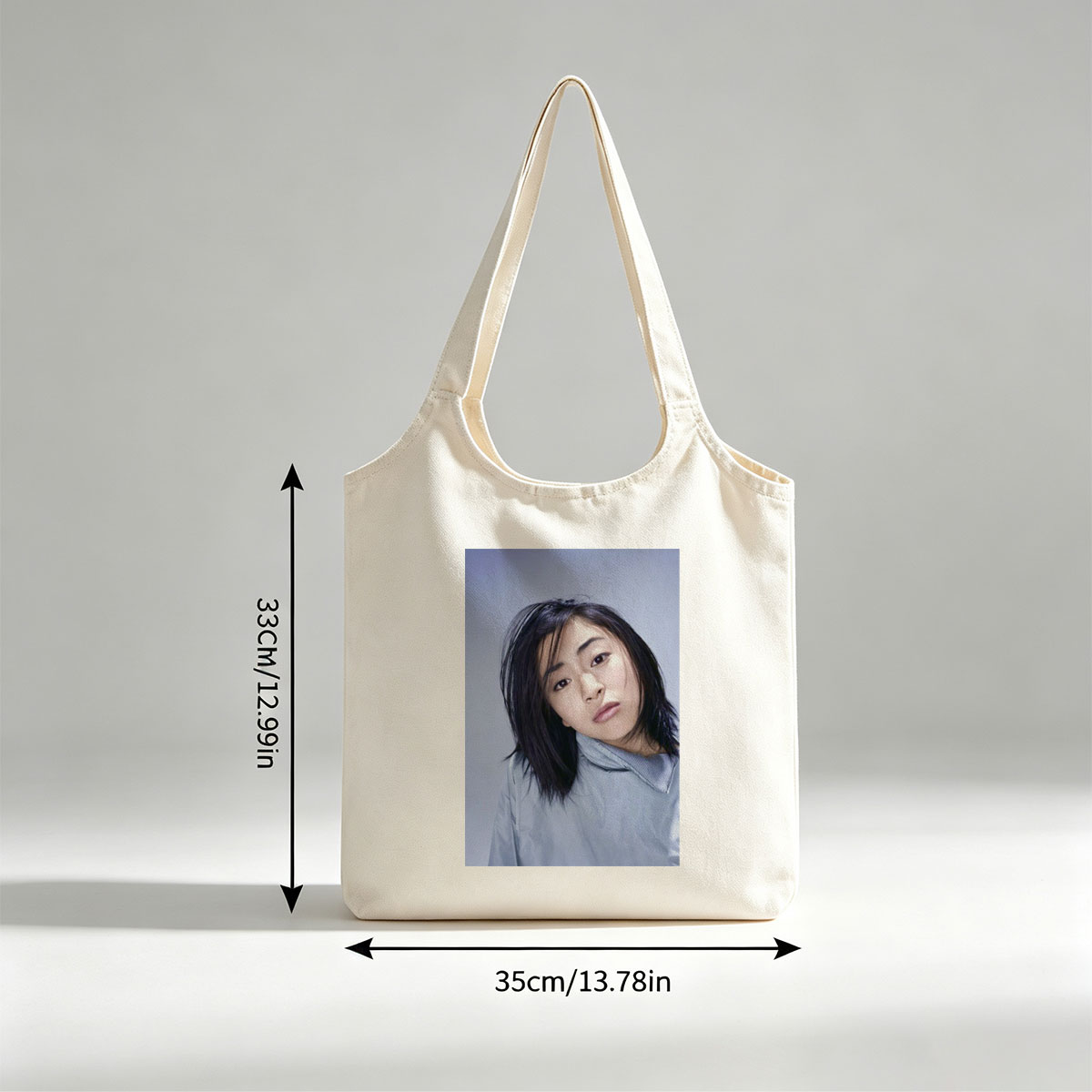 Yuki Kajiura in a Serene Portrait Wearing a Light Blue Collared Shirt Against a Soft Gray Background - Canvas shoulder bags/
