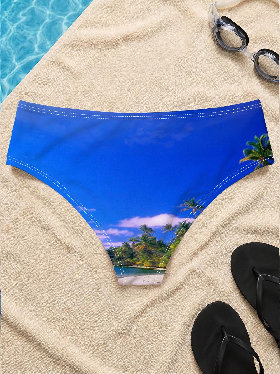Seagulls soar over a pristine tropical beach with crystal-clear waters and palm trees under a vibrant blue sky. -  Men's swim trunks
