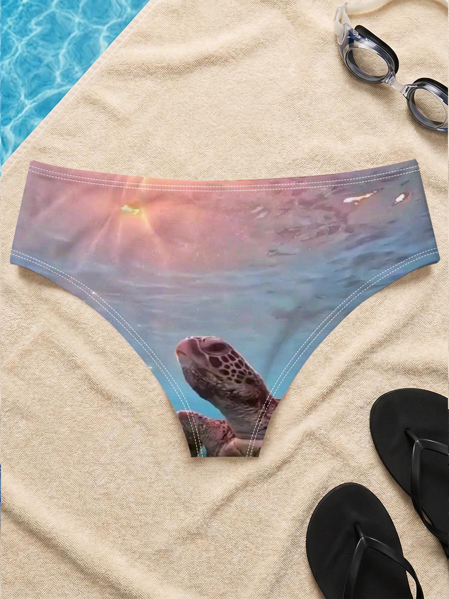 Sea turtle swims gracefully underwater as sunlight filters through the ocean surface. -  Men's swim trunks