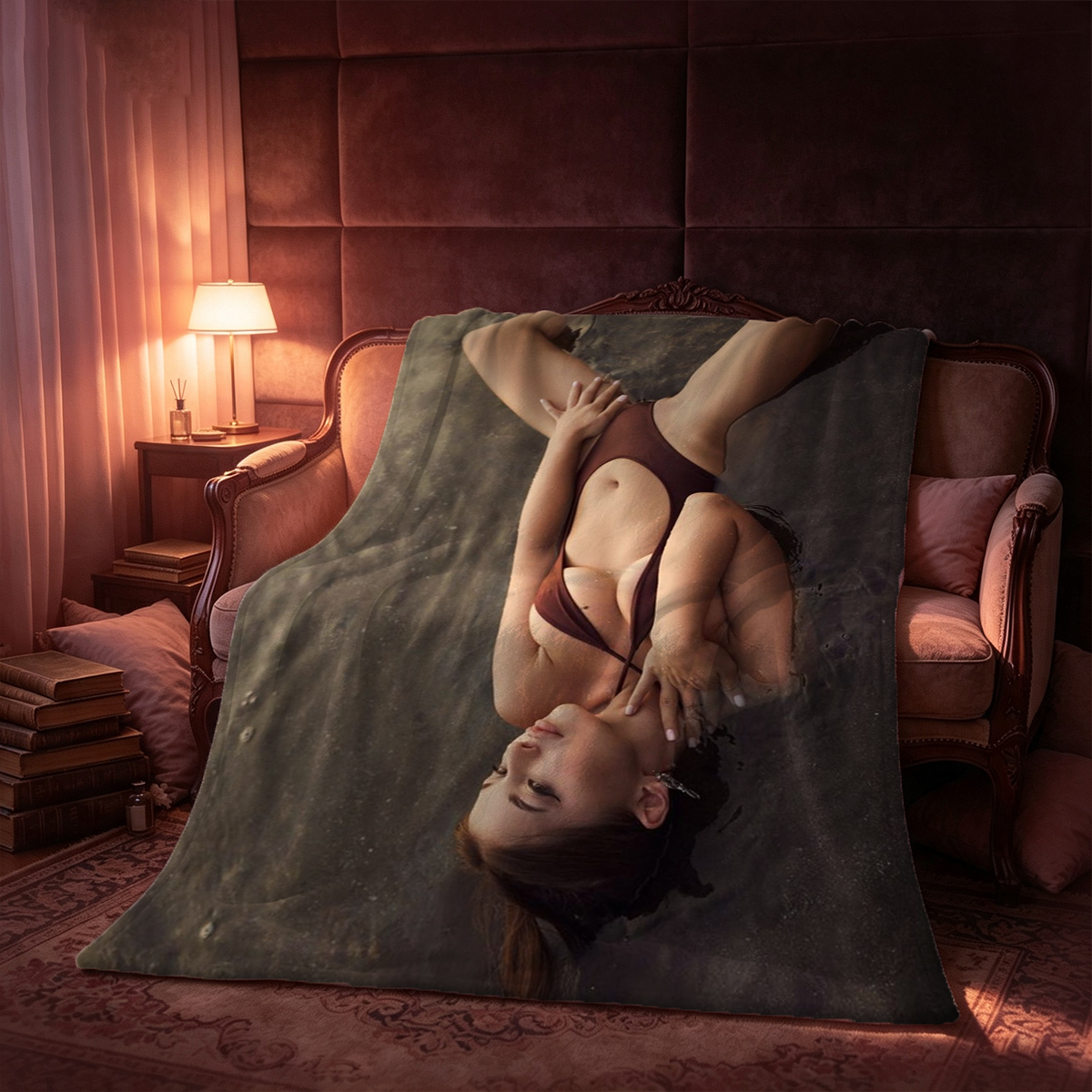 A woman with long black hair in a black crop top and red mini skirt kneeling on a couch. - Blanket