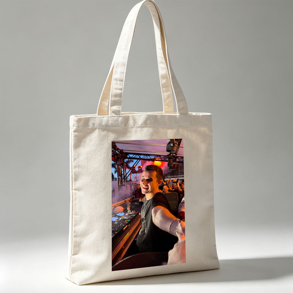 Martin Garrix at a Live DJ Set Performing for an Energetic Crowd Under Colorful Stage Lights - Canvas tote bags