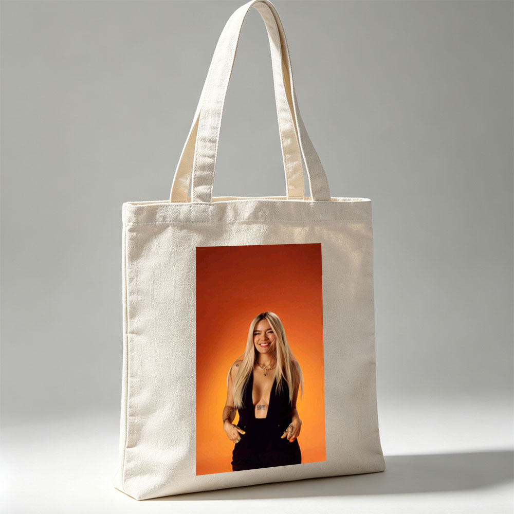 Bebe Rexha in a Bold Black Outfit Against a Vibrant Orange Background, Smiling with Confidence - Canvas tote bags