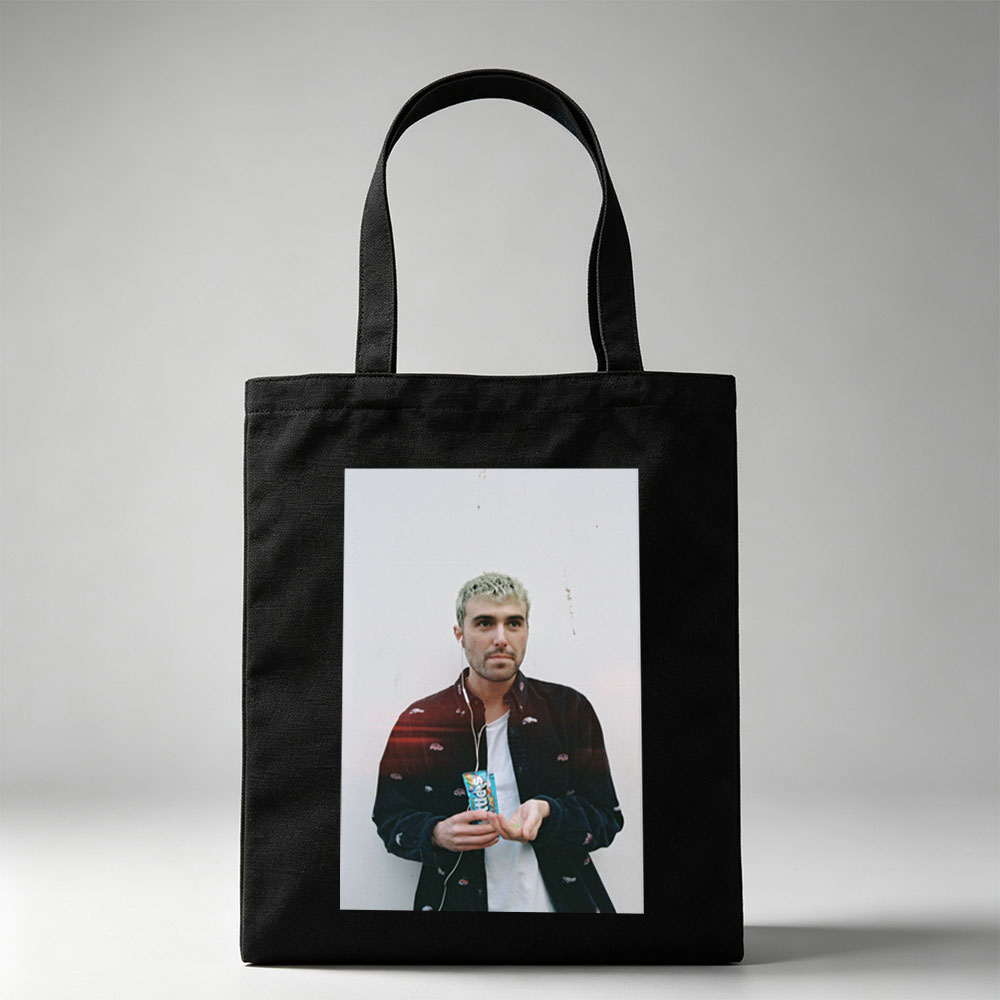 Lauv Standing Against White Wall Holding Candy Bar with Earphones - Canvas tote bags