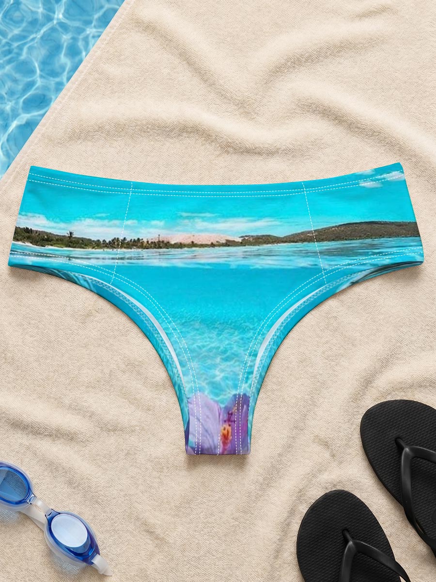 Hand holding a pink hibiscus flower over crystal-clear turquoise water under a bright blue sky. -  Men's swim trunks