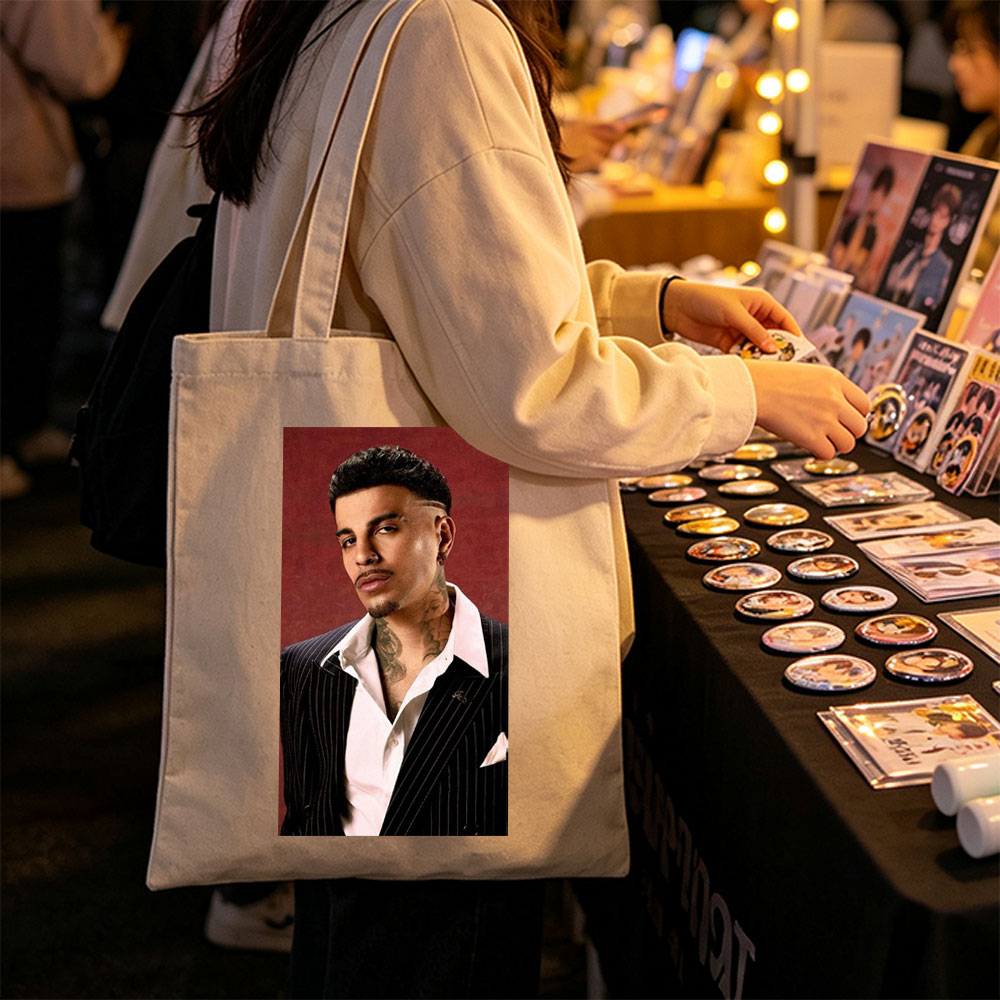 Maluma in a Pinstripe Suit with Visible Neck Tattoos Against a Red Background - Canvas tote bags