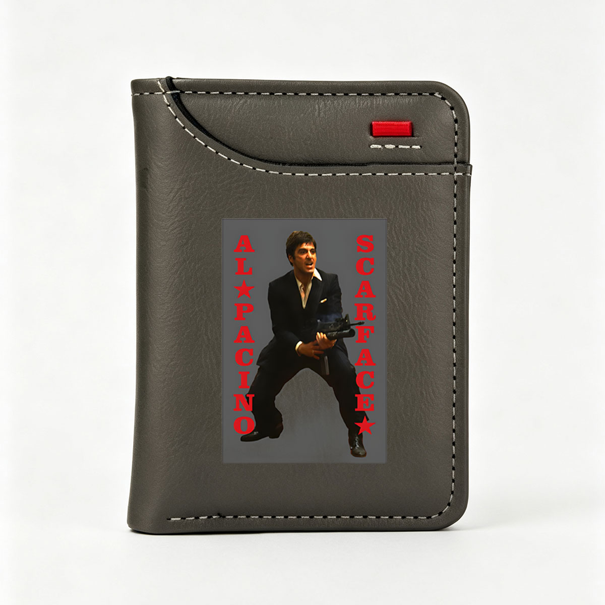 Al Pacino as Scarface, iconic gangster film character, holding a machine gun in a dramatic pose. - Vertical Style Wallet